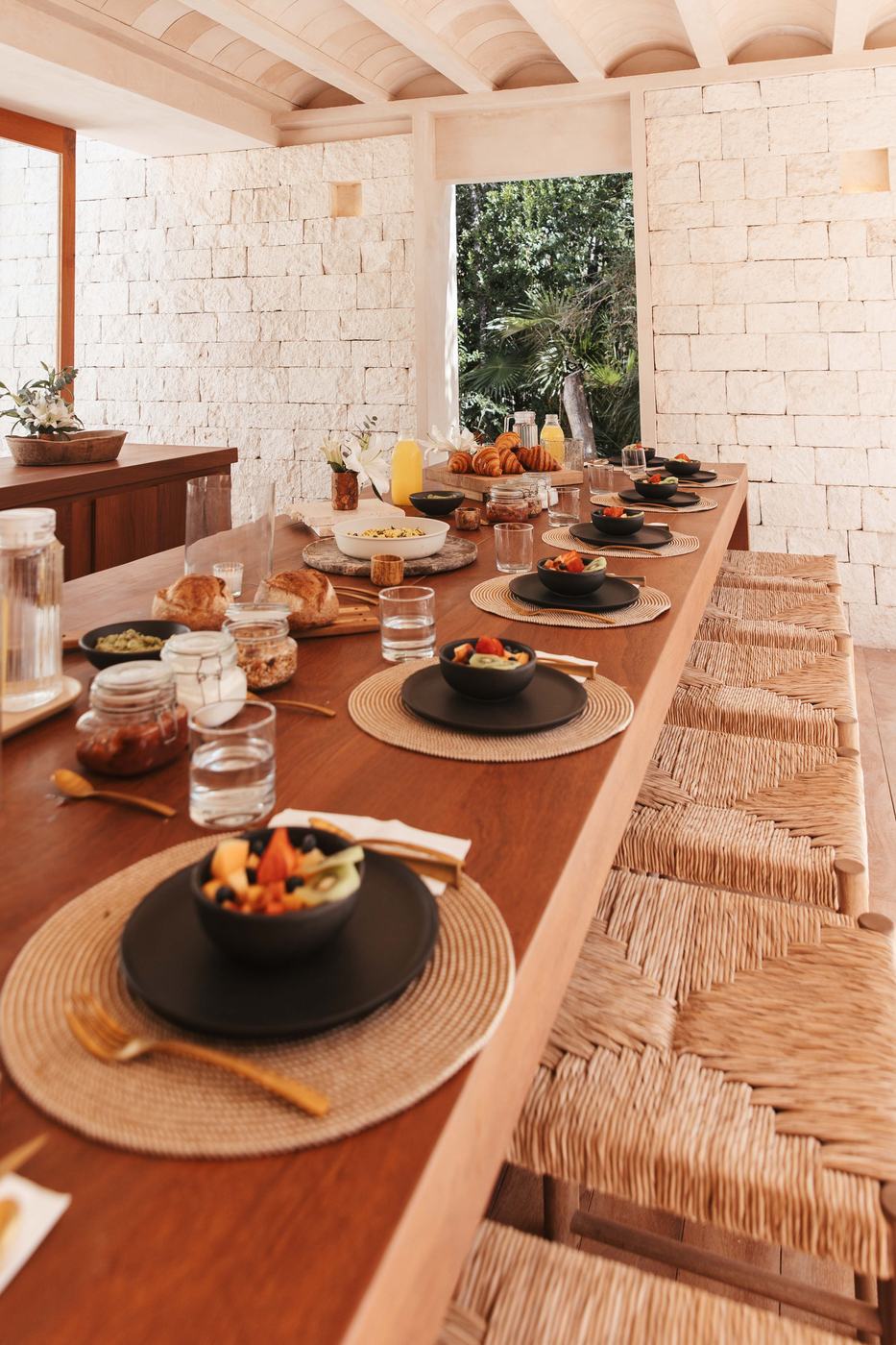 Long wooden table set for a group breakfast