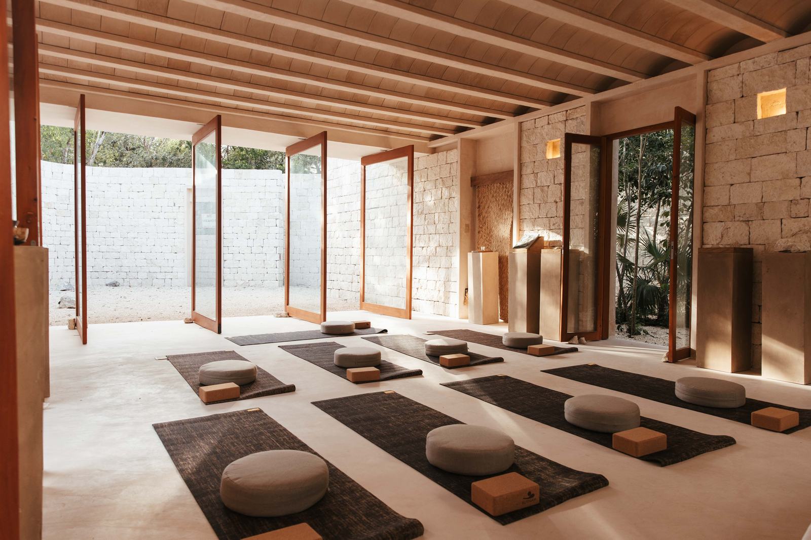 Yoga mats and cushions laid out in Zoco, open to the garden