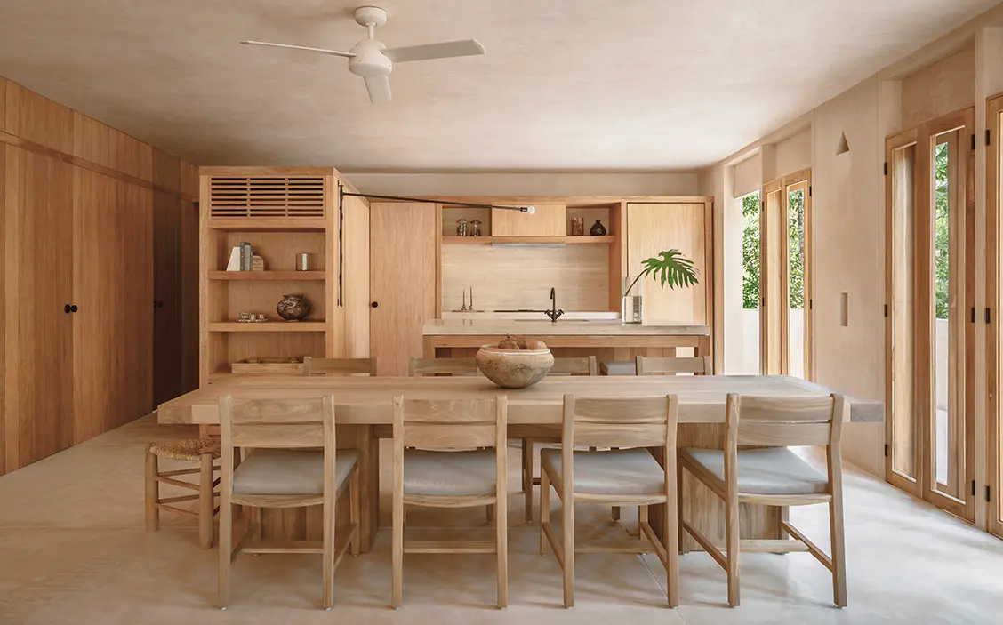 dining room and kitchen with local, light wood furnishings