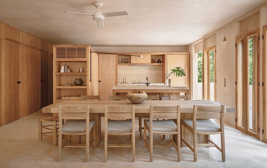 contemporary kitchen with light wood accents and large windows in tulum
